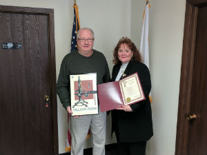 Rex Parker, a former Park Ridge alderman and artist, joins State Senator Laura Murphy (D-Des Plaines) in celebrating the 115th anniversary of the Village Press.